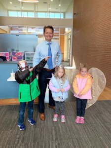Attorney Chad Jones with kids and their new jackets from Coats for Kids event