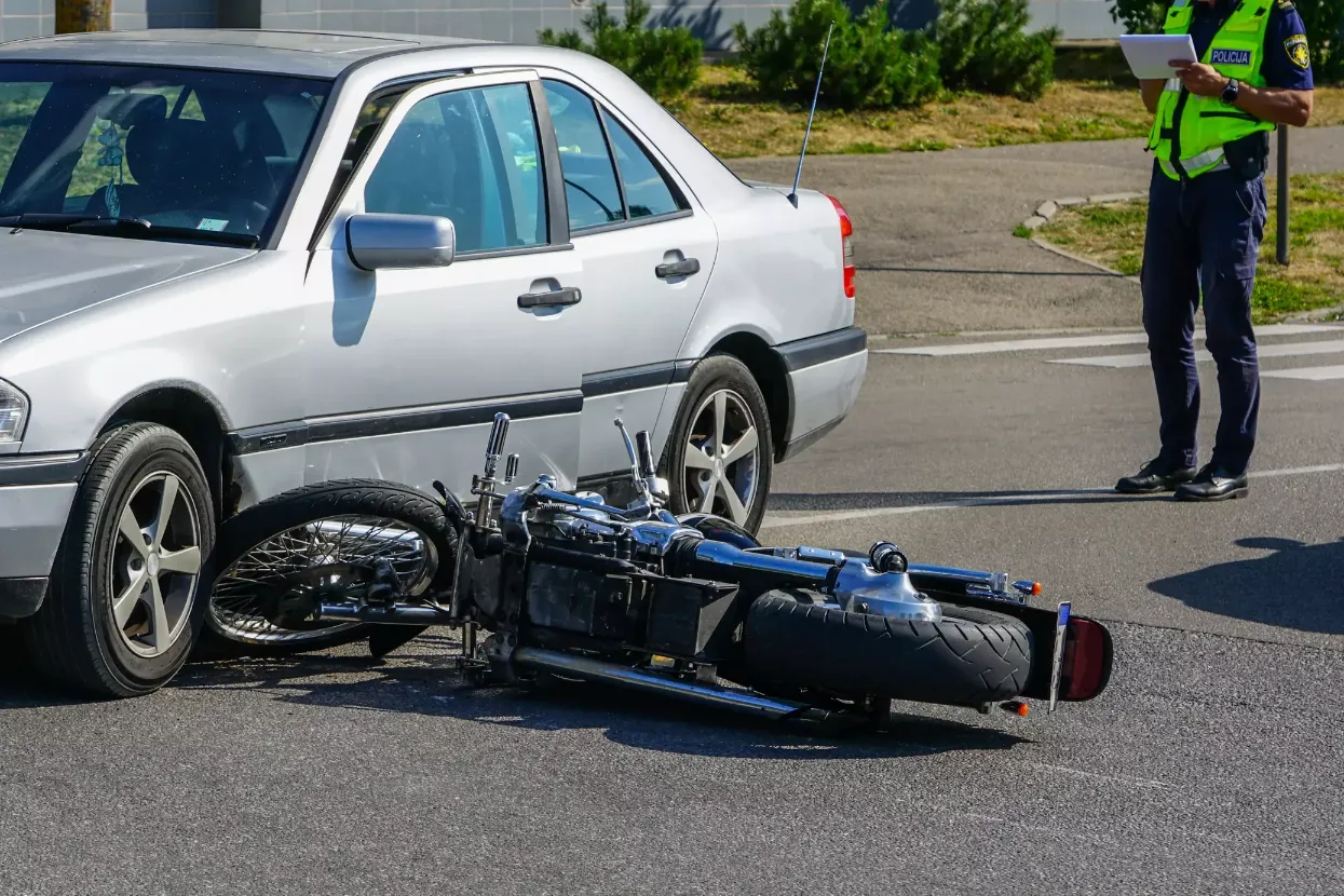 A motorcycle after it's hit a car. 