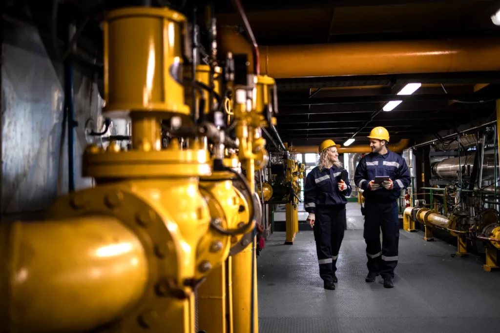 Oil and gas workers walking through a hallway.