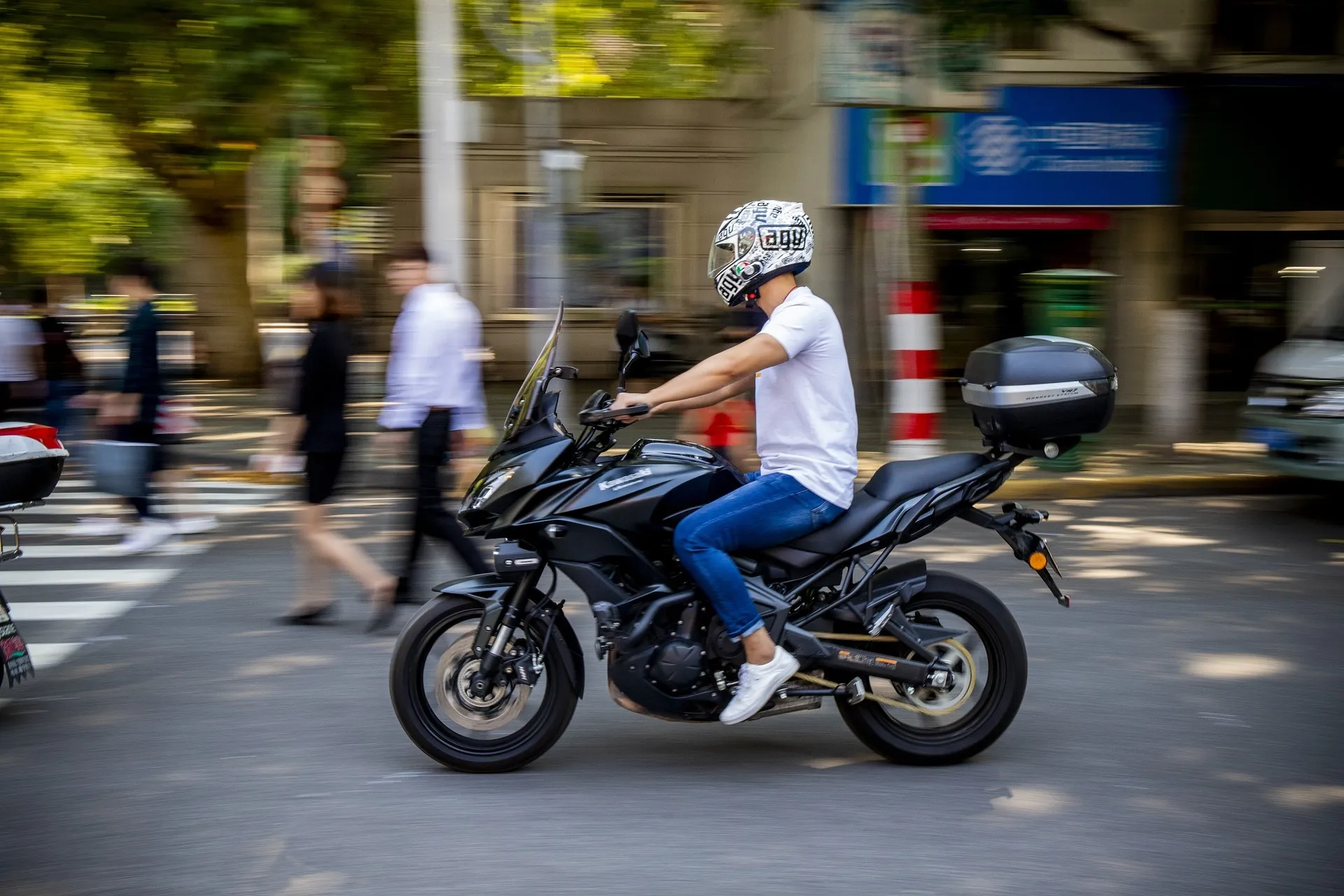 A motorcycle rider on a downtown street.