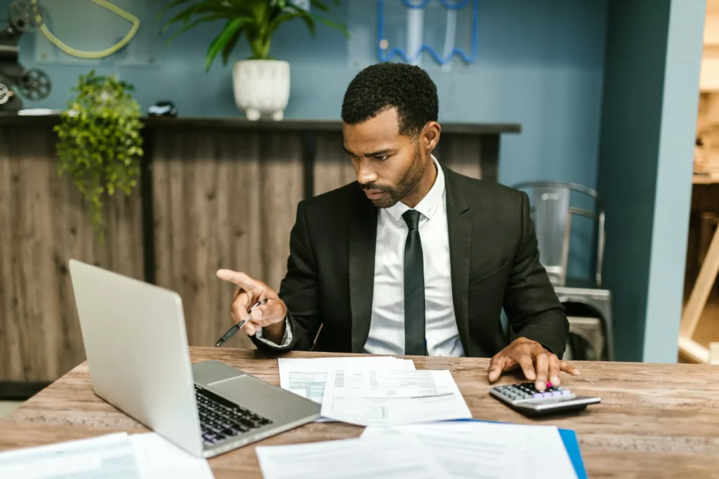 Injury lawyer pointing to a laptop.