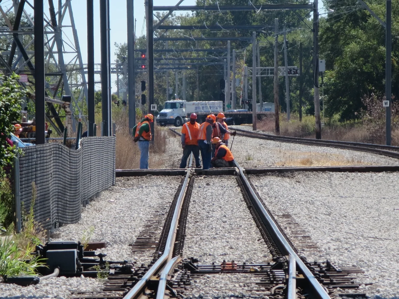 Railroad workers on tracks.