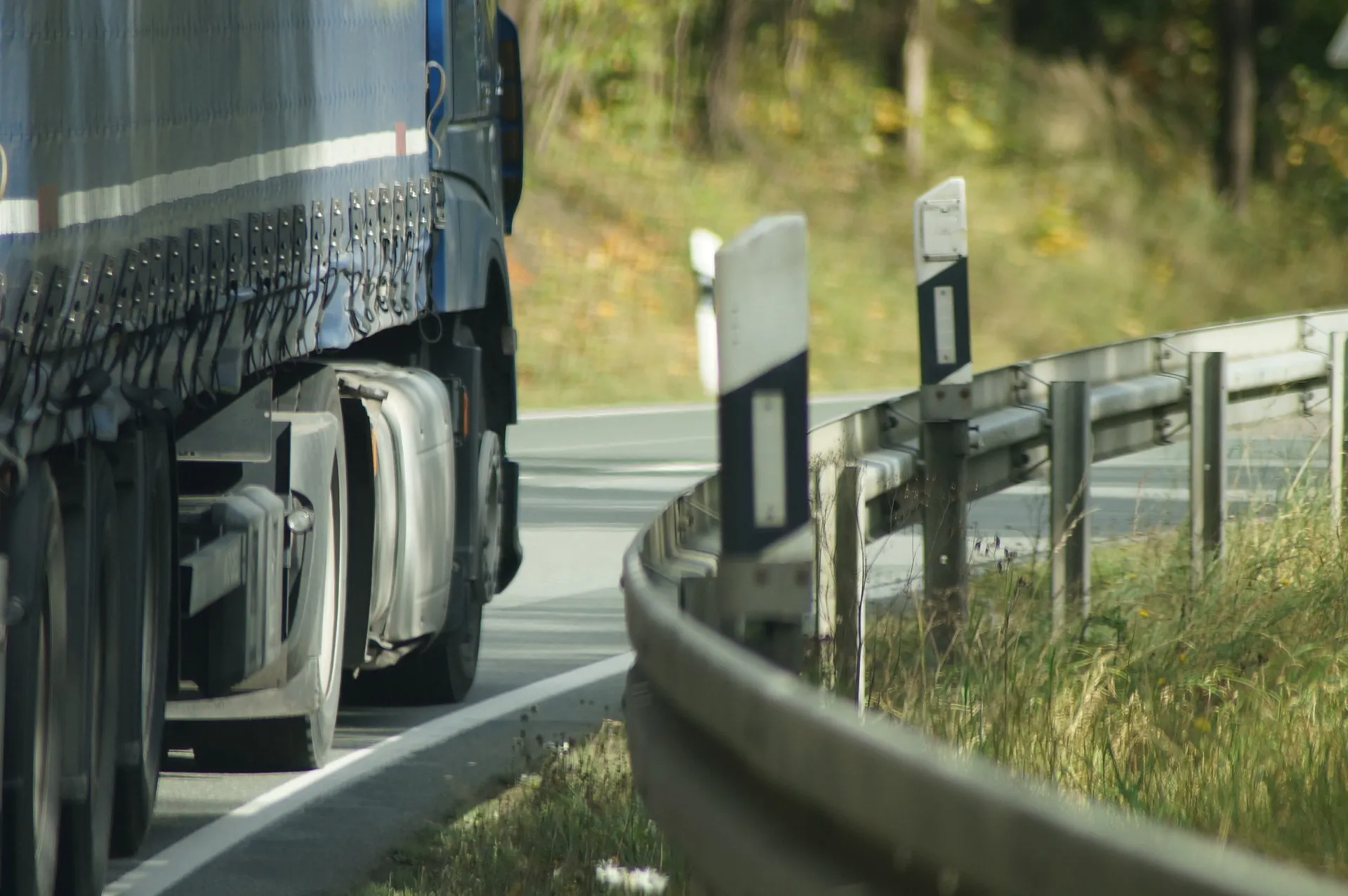 A semi-truck driving along a highway.