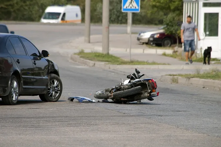 A crashed motorcycle in the road.