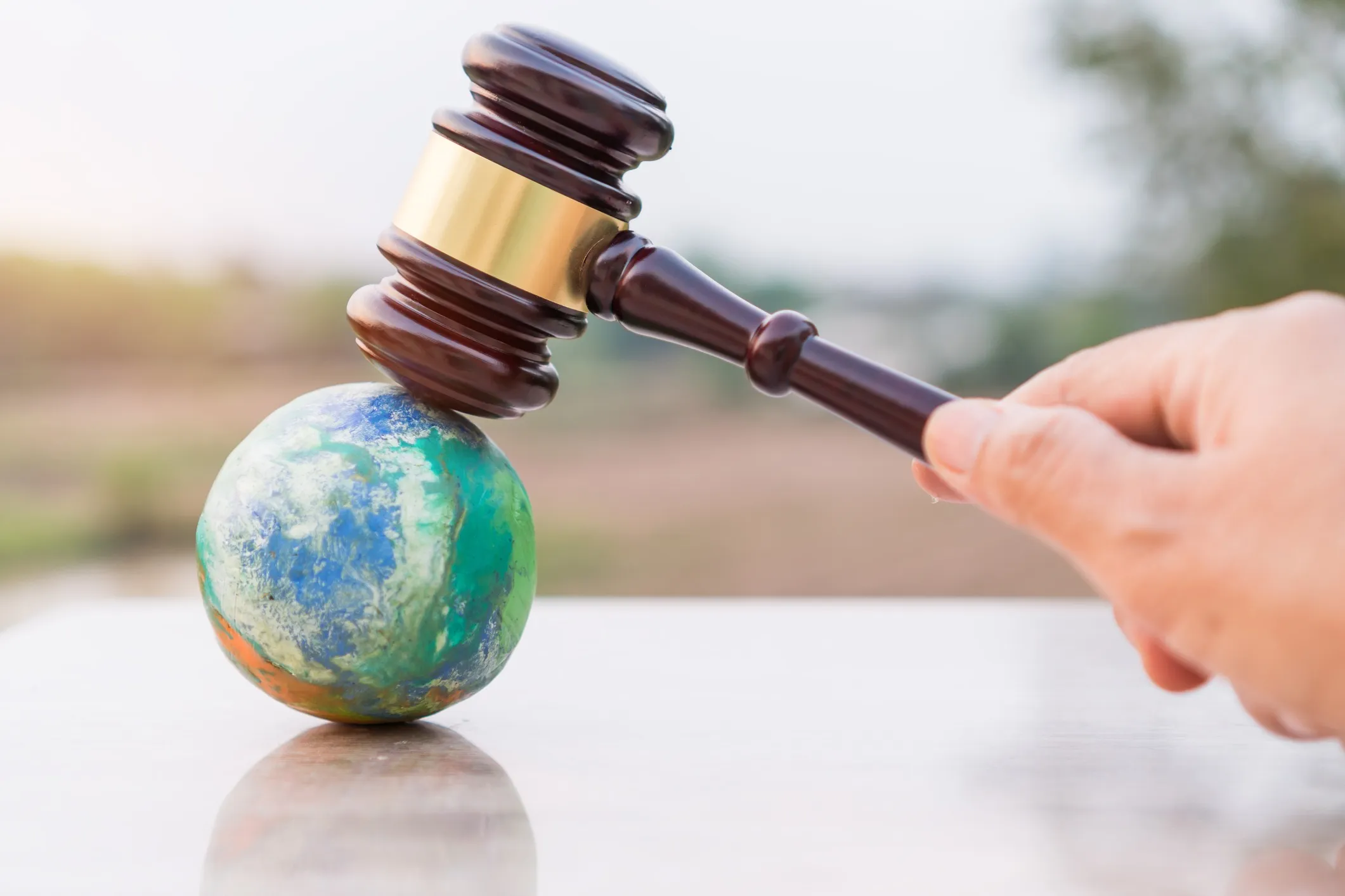 A gavel resting on a globe.