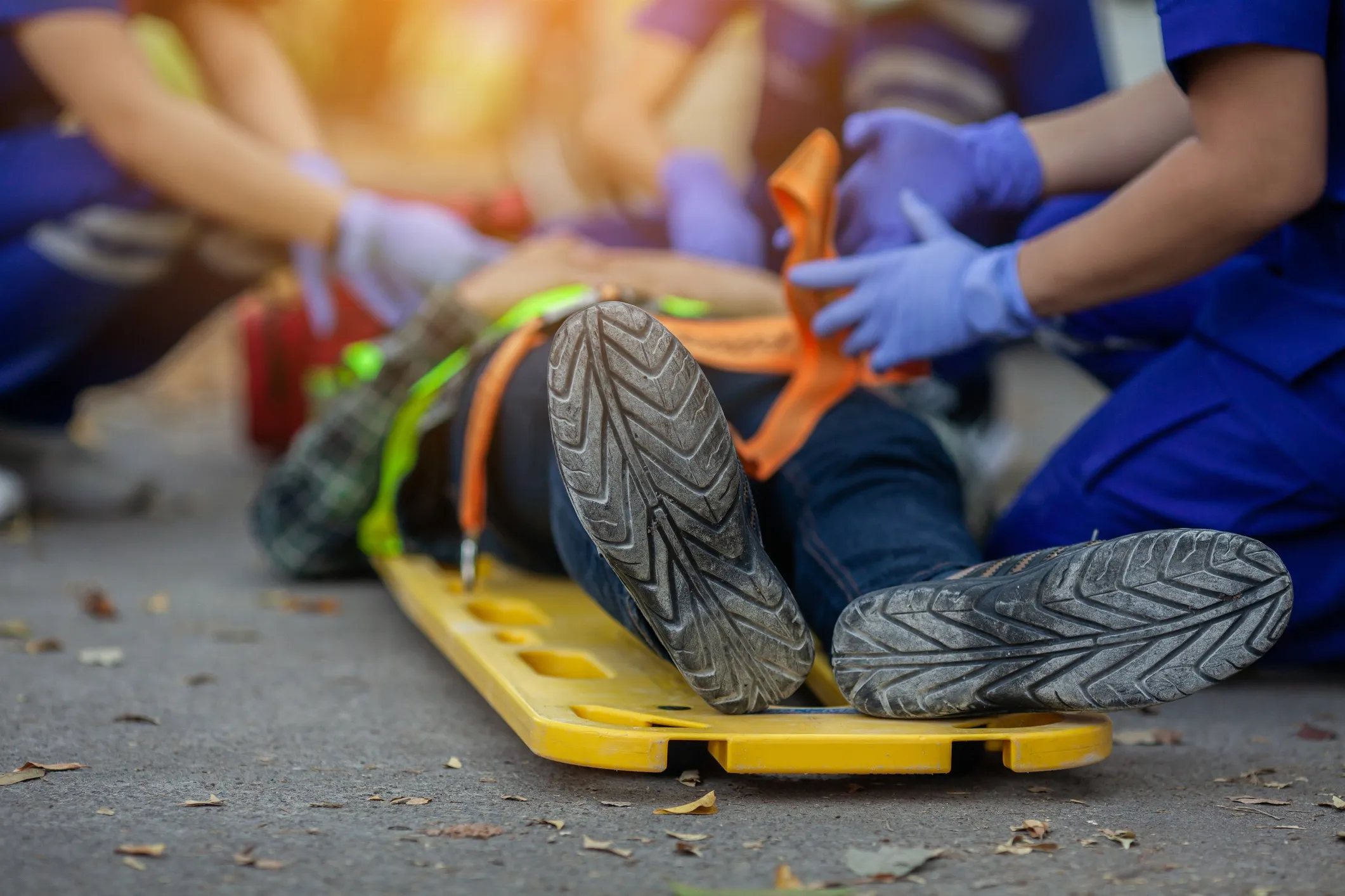An injured worker being loaded on a support board.
