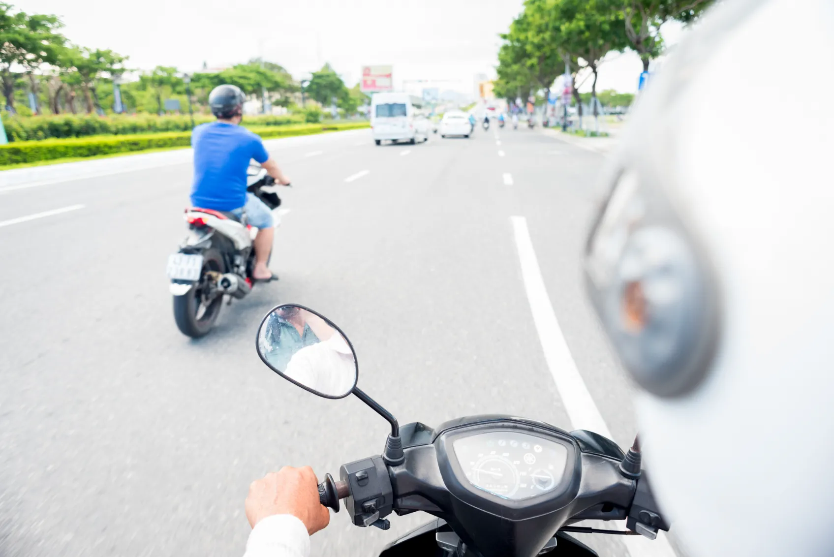 A motorcycle rider splitting the lanes.