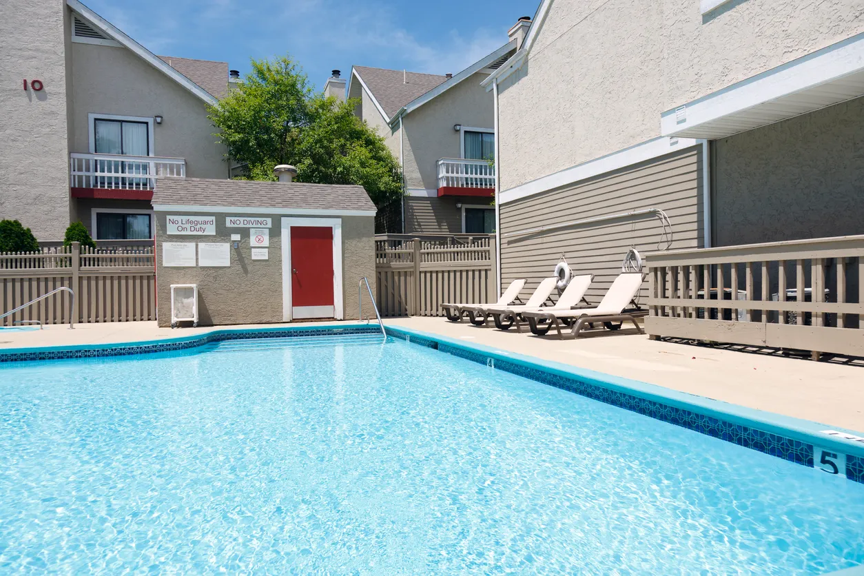A pool with pool chairs.