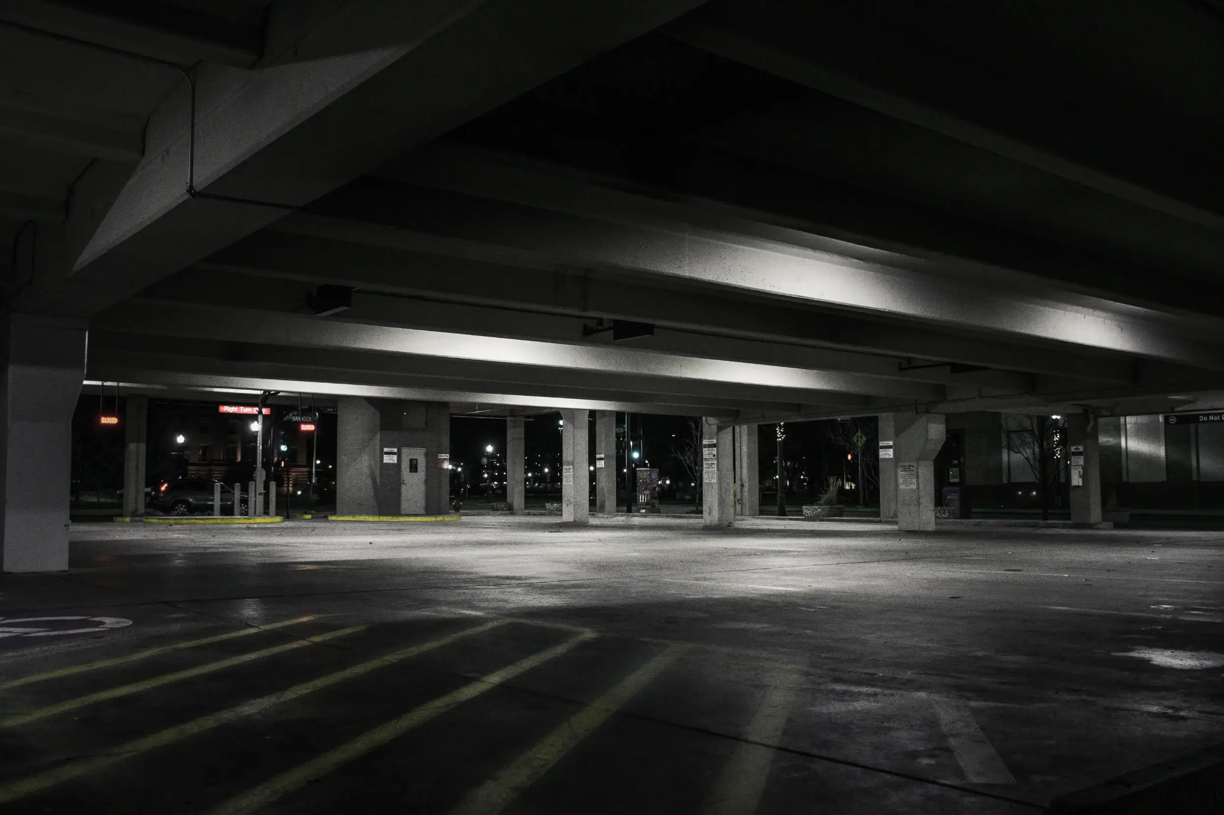 A dark, empty parking lot at night.