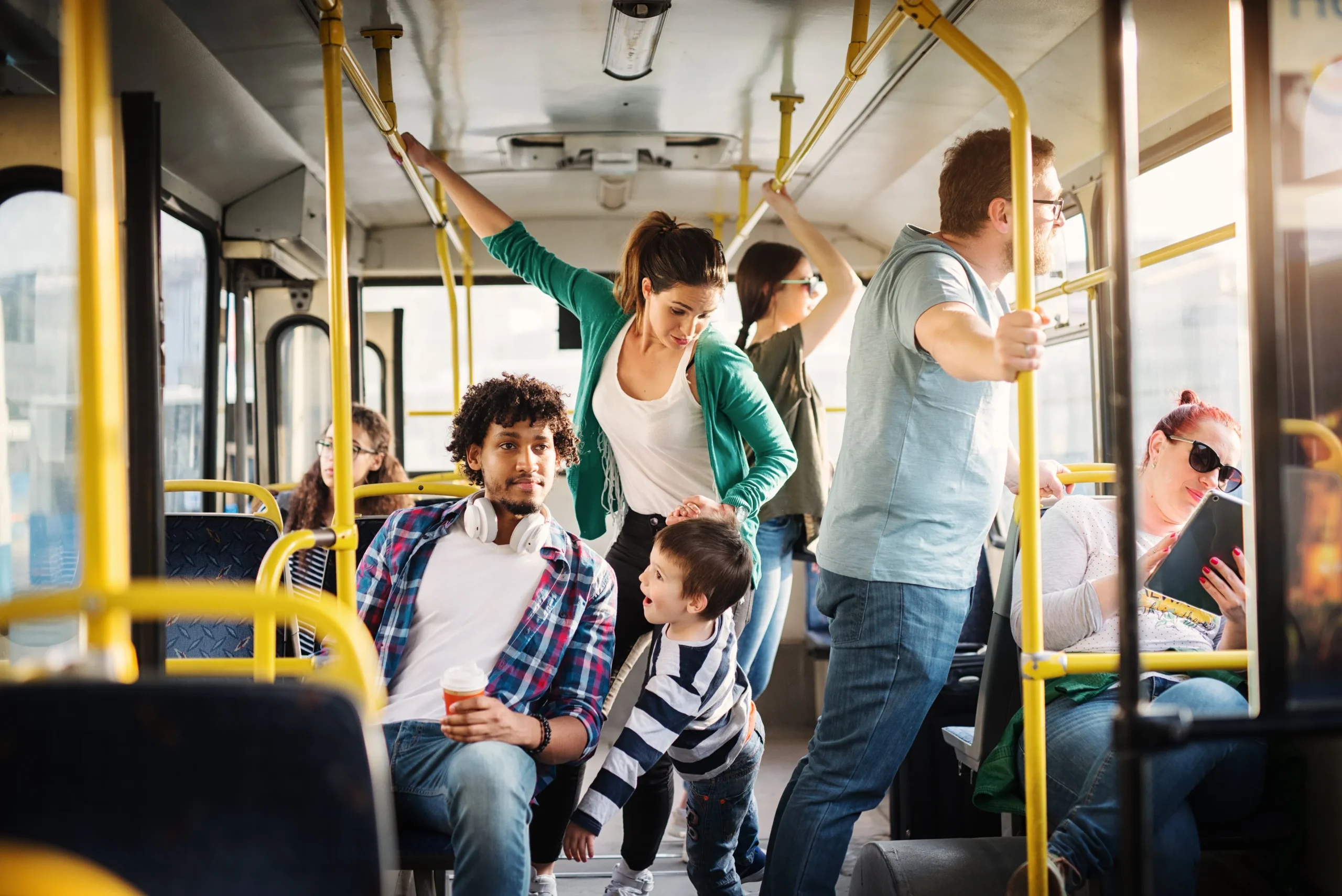 A group of bus riders in a public bus.